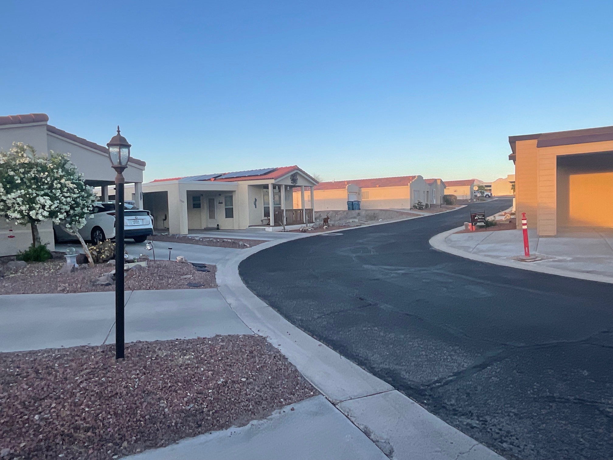 Residential neighborhood with single-story homes, paved streets, and desert landscaping.